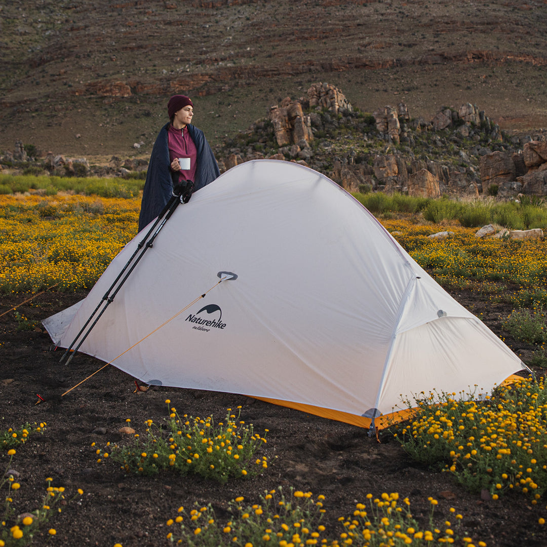 woman standing beside naturehike cloud wing tent in outdoor