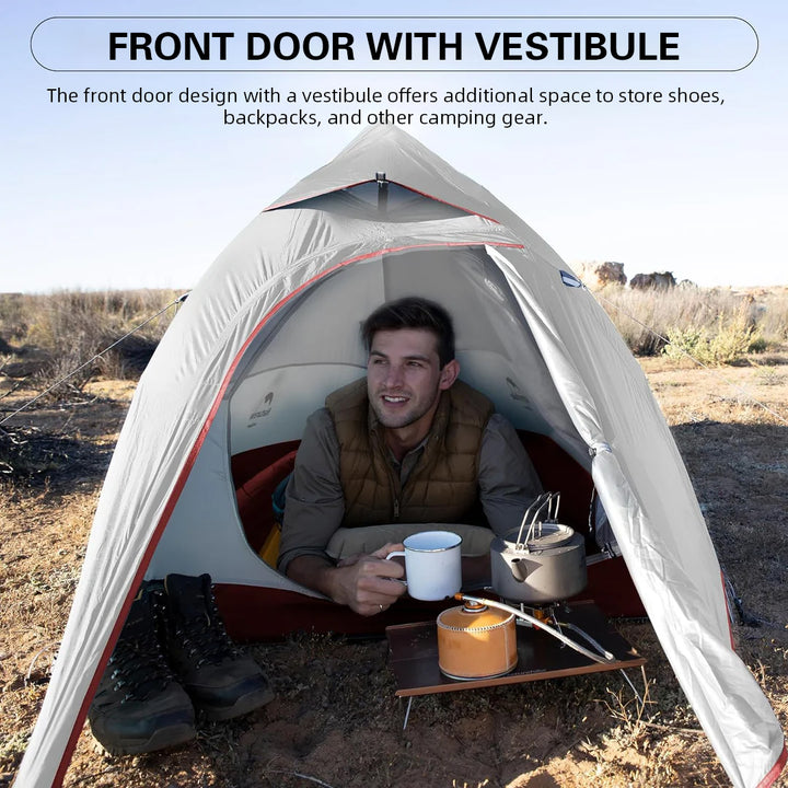 A man sits in a tent with a cup of coffee in his hand. The door of the tent is open, and the scenery outside can be seen. The man is wearing a vest and looks like he is enjoying his camping time. The whole scene gives people a sense of tranquility and relaxation.