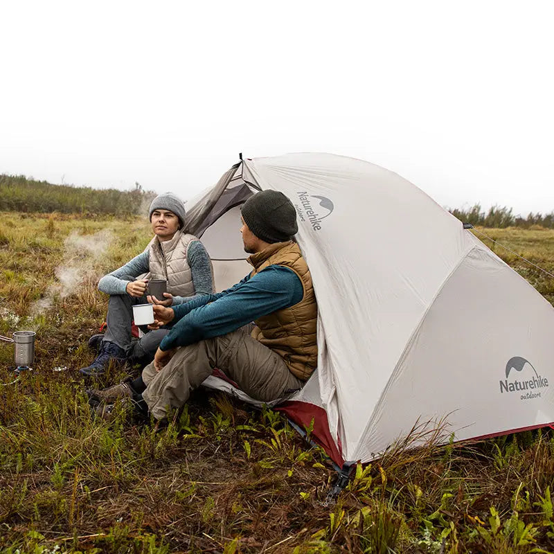 The two were enjoying a sunny day as they set up their Star-River 4-Season Backpacking Tent at the foot of the mountain. The magnificent mountains in the background added a touch of natural beauty to their camping trip.